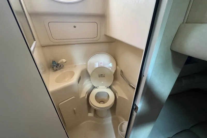 Slide: The Image of Bathroom interior of 1997 Sea Ray 400 Sundancer yacht, featuring toilet and sink. - 54