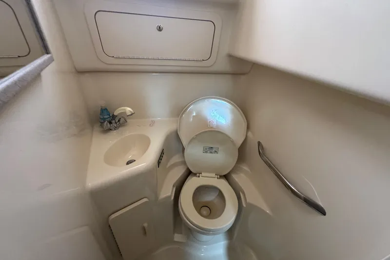 Slide: The Image of Bathroom interior of 1997 Sea Ray 400 Sundancer yacht, featuring toilet and sink. - 56