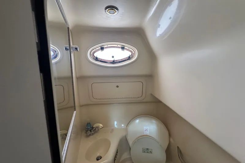 Slide: The Image of Interior of 1997 Sea Ray 400 Sundancer yacht bathroom with sink and porthole window. - 57