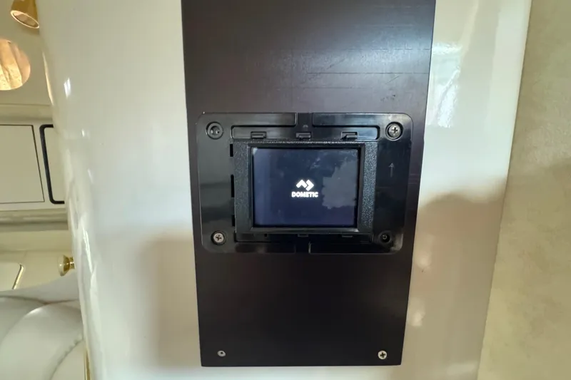 Slide: The Image of Control panel on 1997 Sea Ray 400 Sundancer yacht, featuring Dometic display. - 59