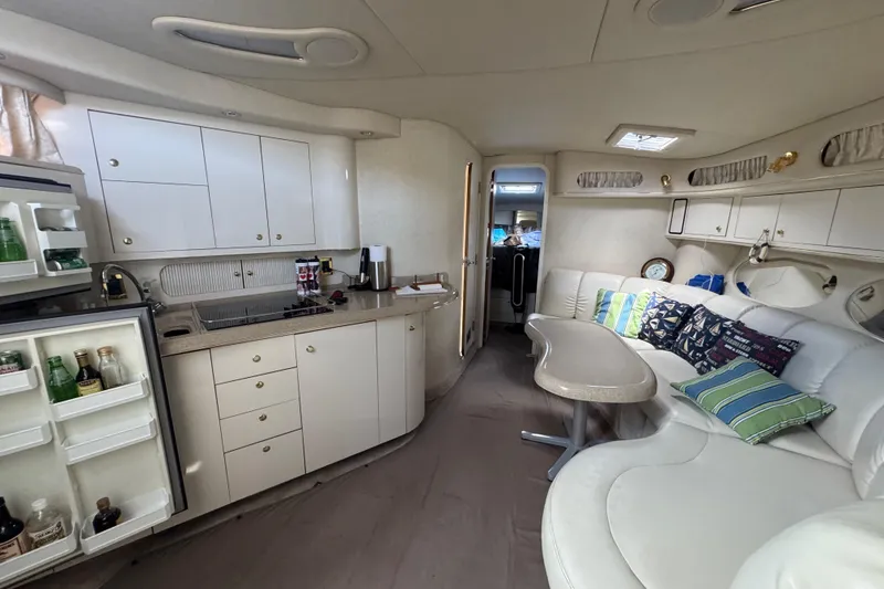 Slide: The Image of Interior of 1997 Sea Ray 400 Sundancer yacht with kitchen and seating area. - 61