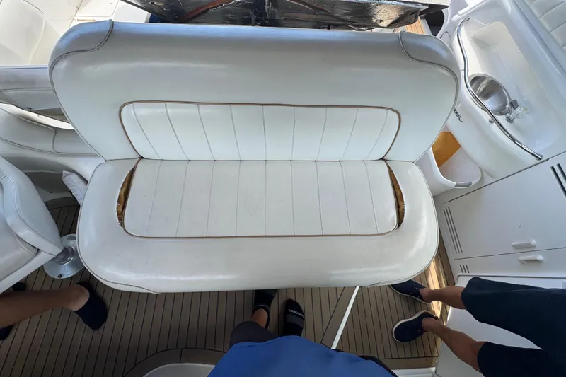 Slide: The Image of White leather seating on 1997 Sea Ray 400 Sundancer boat, with visible wear. - 63