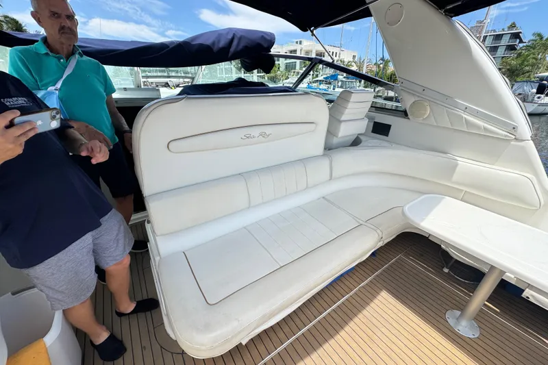 Slide: The Image of 1997 Sea Ray 400 Sundancer yacht interior with white seating and wooden deck. - 70