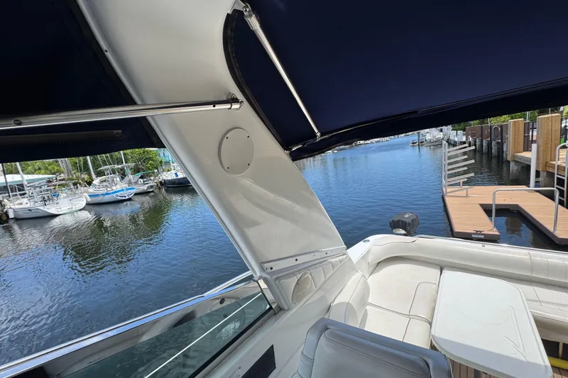 Slide: The Image of 1997 Sea Ray 400 Sundancer yacht interior with marina view, featuring seating and table. - 72