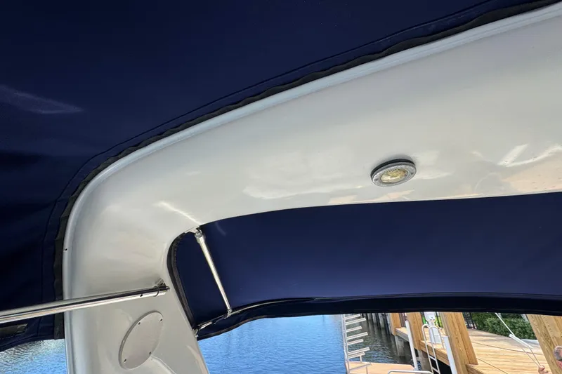 Slide: The Image of 1997 Sea Ray 400 Sundancer boat canopy and light, dockside view. - 73