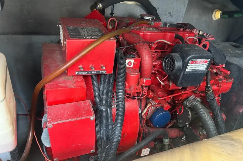 Slide: The Image of Red engine of a 1997 Sea Ray 400 Sundancer boat, featuring control buttons. - 81