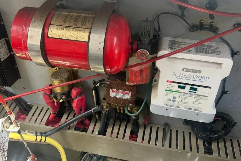 Slide: The Image of Engine compartment of 1997 Sea Ray 400 Sundancer with fire extinguisher and ProNautic charger. - 82