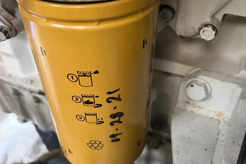 Slide: The Image of Yellow oil filter with instructions, attached to a 1997 Sea Ray 400 Sundancer engine. - 85