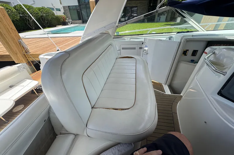 Slide: The Image of 1997 Sea Ray 400 Sundancer interior with white seating and wooden deck. - 9