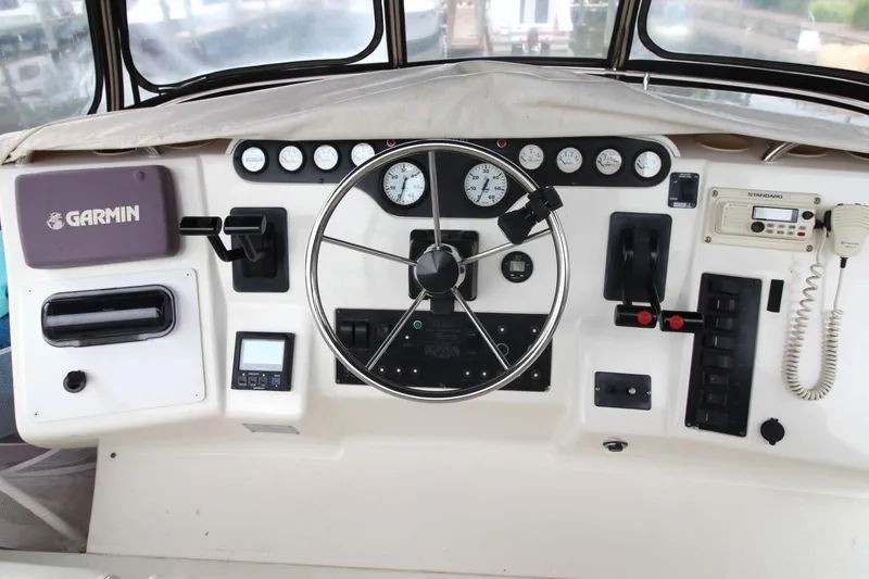 Slide: The Image of 1997 Silverton 402 Motor Yacht helm with Garmin navigation and control panel. - 17