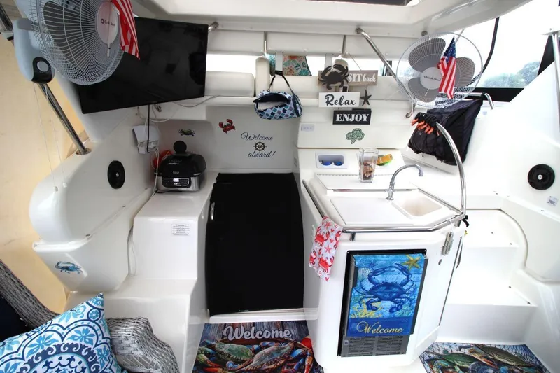 Slide: The Image of Interior of a 1997 Silverton 402 Motor Yacht with cozy decor and kitchen amenities. - 18