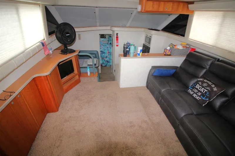 Slide: The Image of Interior of 1997 Silverton 402 Motor Yacht with sofa, kitchenette, and decor. - 19