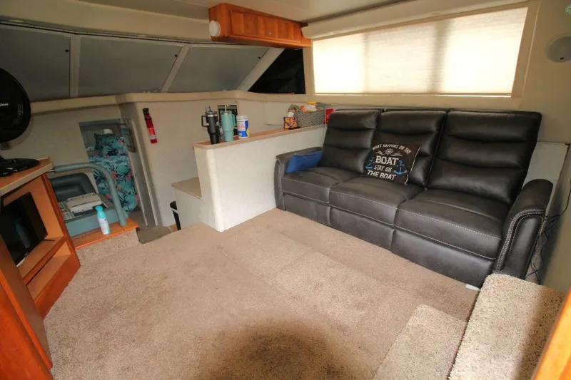 Slide: The Image of Interior of 1997 Silverton 402 Motor Yacht with leather sofa and cozy decor. - 20
