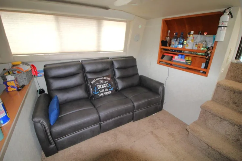 Slide: The Image of Interior of 1997 Silverton 402 Motor Yacht with leather sofa and built-in bar. - 21