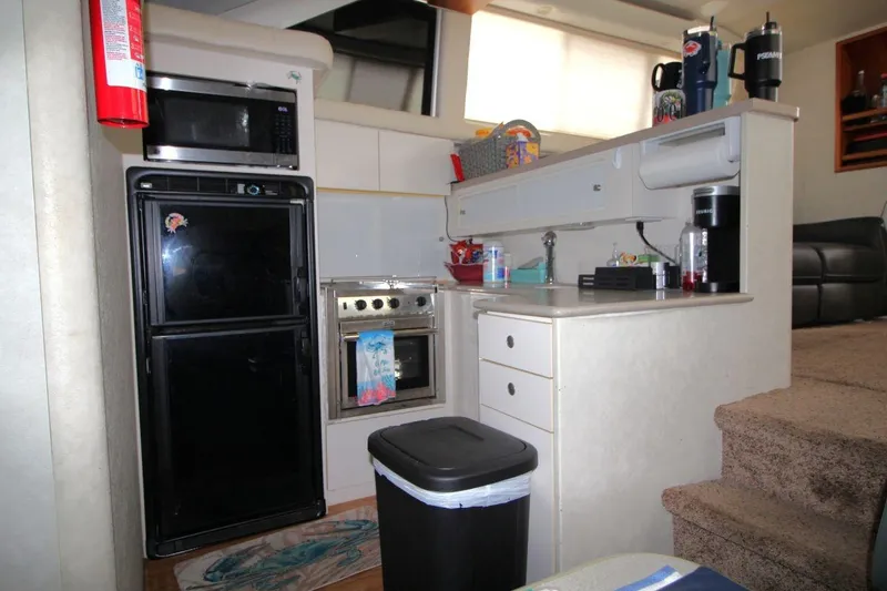 Slide: The Image of 1997 Silverton 402 Motor Yacht kitchen with appliances, sink, and storage cabinets. - 24
