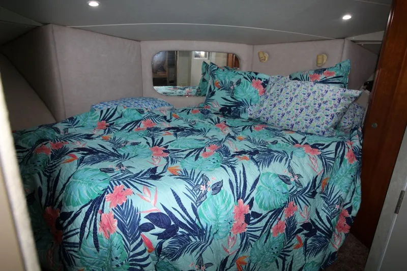 Slide: The Image of Cozy bedroom in 1997 Silverton 402 Motor Yacht with tropical-themed bedding. - 25