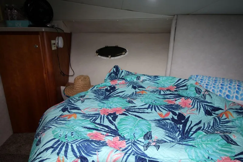 Slide: The Image of Cozy cabin interior of 1997 Silverton 402 Motor Yacht with floral bedding. - 26