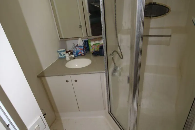 Slide: The Image of Bathroom interior of a 1997 Silverton 402 Motor Yacht with shower and sink. - 28