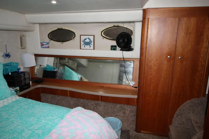 Slide: The Image of Interior of 1997 Silverton 402 Motor Yacht with wood cabinetry and nautical decor. - 31