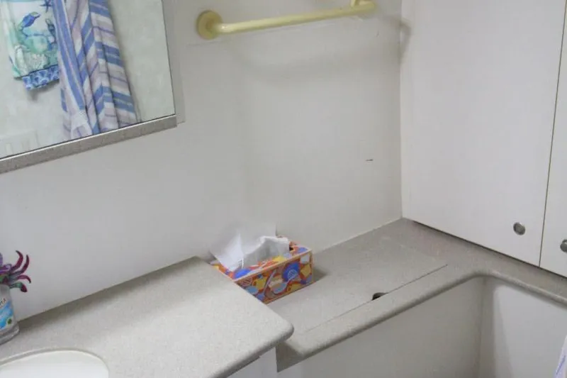 Slide: The Image of Bathroom interior of 1997 Silverton 402 Motor Yacht with countertop and mirror. - 33