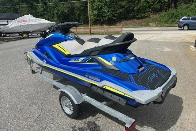 Slide: The Image of 2020 Yamaha WaveRunner FX Cruiser SVHO on trailer, vibrant blue and yellow design. - 4