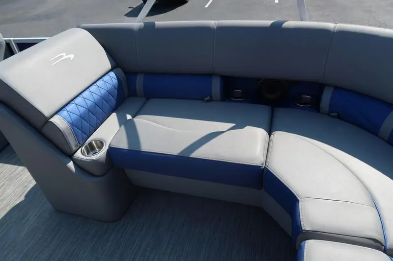 Slide: The Image of Luxurious seating on 2021 Bennington 21 LL boat, featuring blue and gray upholstery with cup holders. - 13