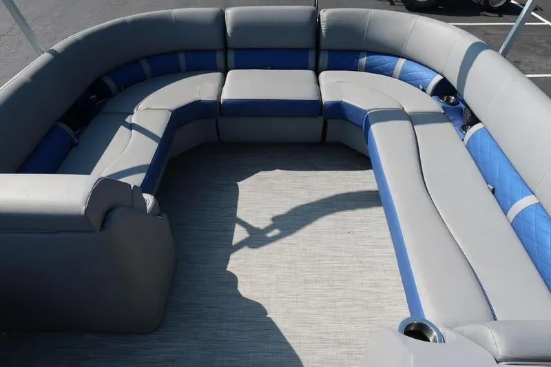 Slide: The Image of 2021 Bennington 21 LL boat interior with gray and blue cushioned seating. - 14