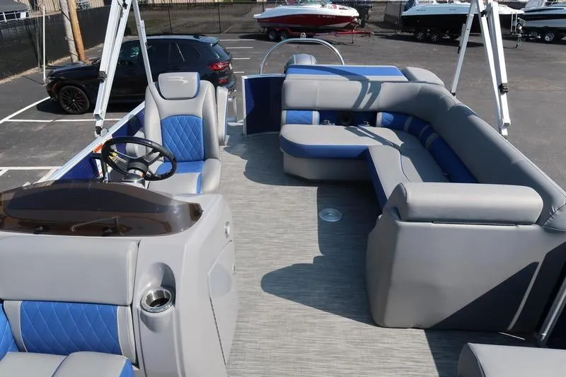 Slide: The Image of 2021 Bennington 21 LL pontoon boat interior with gray and blue seating. - 17