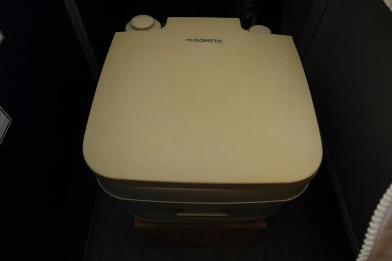 Slide: The Image of Portable Dometic toilet in a 2021 Bennington 21 LL boat interior. - 19
