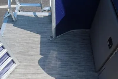 Slide: The Image of 2021 Bennington 21 LL boat interior with gray flooring and blue accents. - 2