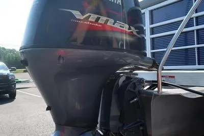 Slide: The Image of 2021 Bennington 21 LL with Yamaha VMAX outboard motor in a parking lot. - 7