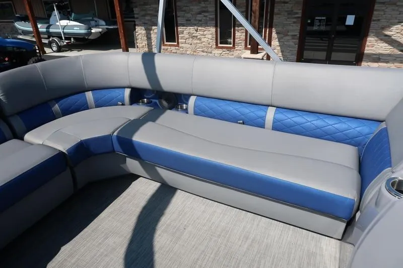 Slide: The Image of 2021 Bennington 21 LL pontoon boat interior with gray and blue seating. - 9
