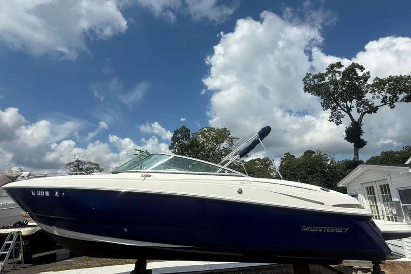 The Image of 2008 Monterey 254FS boat on display under a partly cloudy sky. - 1