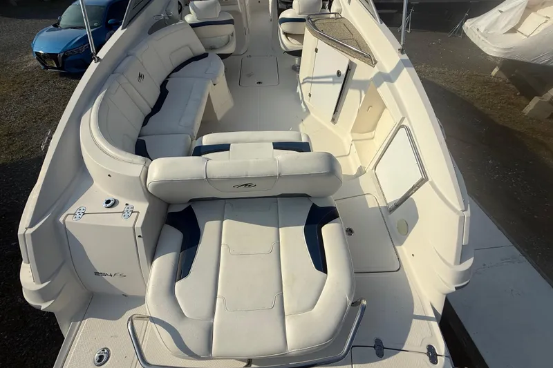 Slide: The Image of 2008 Monterey 254FS boat interior with white seating and spacious layout. - 10
