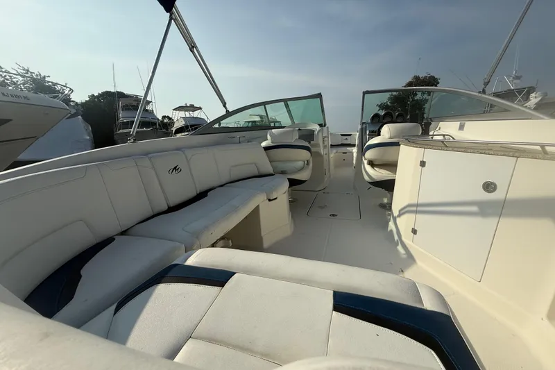 Slide: The Image of 2008 Monterey 254FS boat interior with white seating and open cockpit design. - 12
