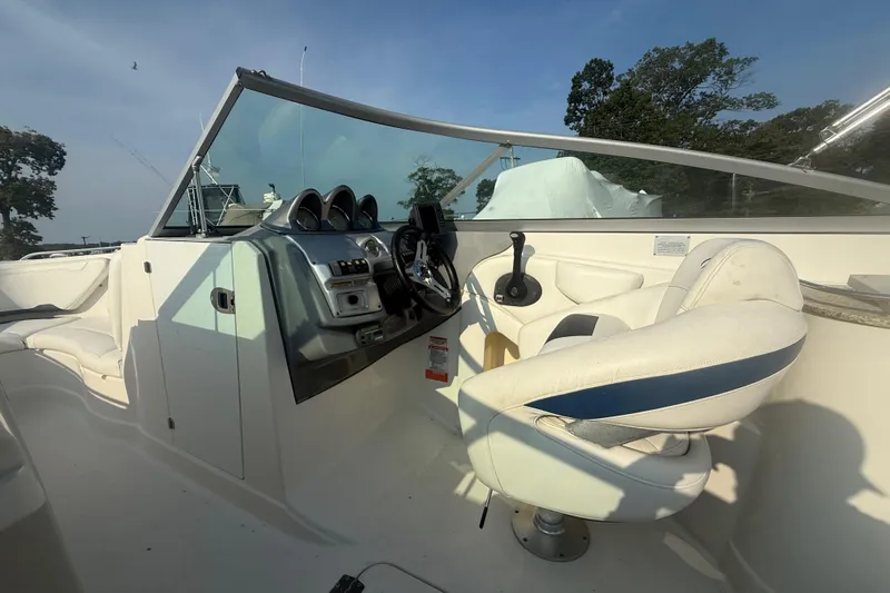 Slide: The Image of 2008 Monterey 254FS boat cockpit with steering wheel and control panel. - 15
