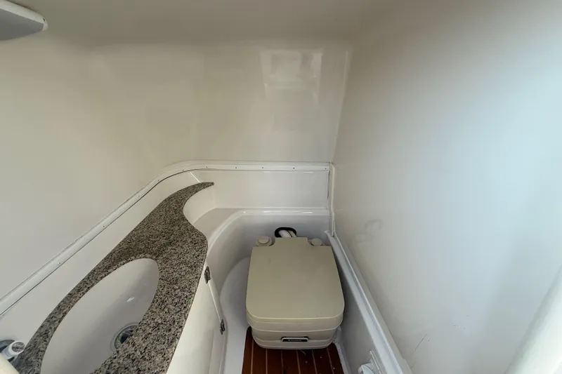 Slide: The Image of 2008 Monterey 254FS boat interior with sink and portable toilet. - 24