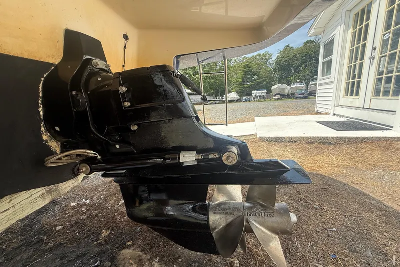 Slide: The Image of 2008 Monterey 254FS boat outdrive with propeller, parked near a building. - 25