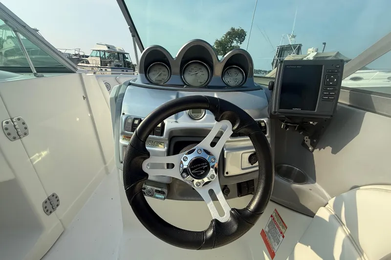 Slide: The Image of Steering console of a 2008 Monterey 254FS boat with gauges and navigation system. - 3