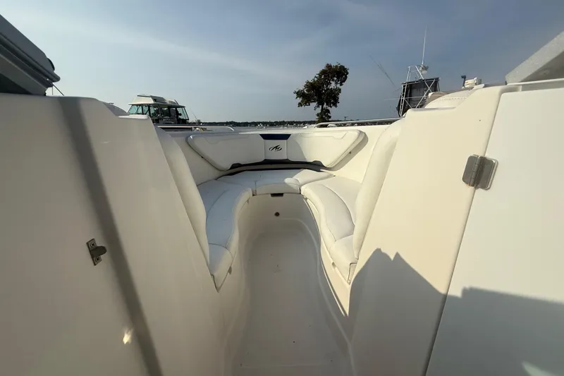 Slide: The Image of 2008 Monterey 254FS boat interior with white seating and open deck view. - 4