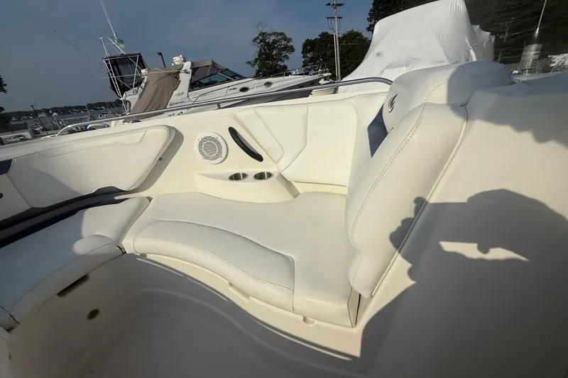 Slide: The Image of 2008 Monterey 254FS boat interior with white seating and cup holders. - 6