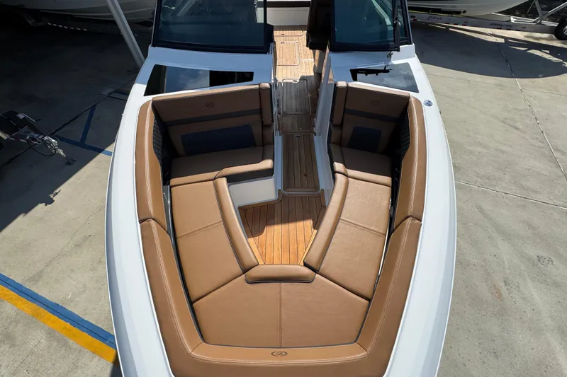Slide: The Image of 2024 Cobalt R33 boat with luxurious tan seating and sleek design. - 22