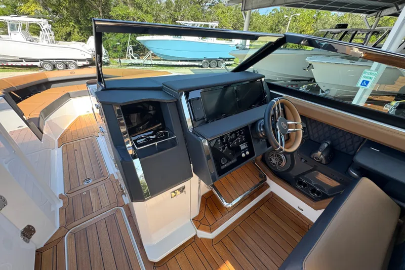 Slide: The Image of 2024 Cobalt R33 boat interior with modern dashboard and wood flooring. - 26