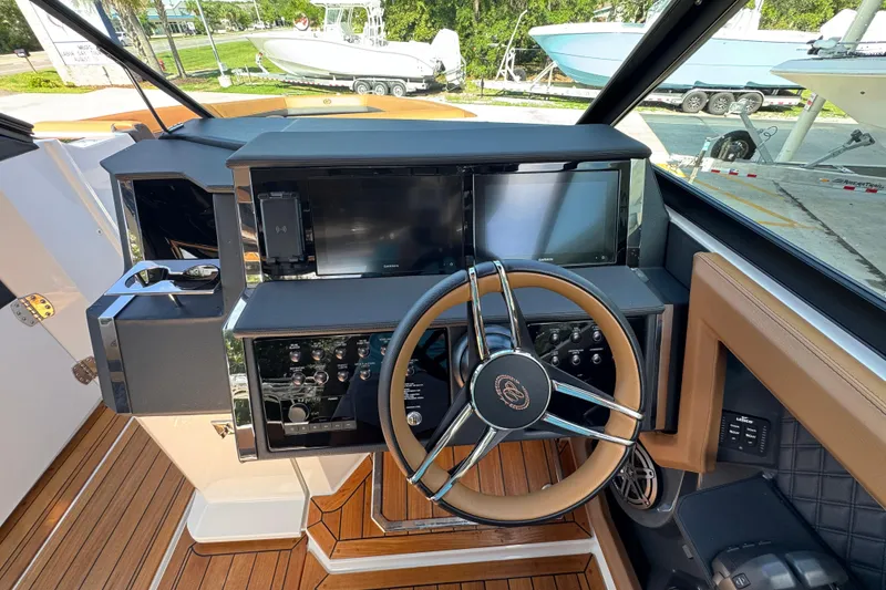 Slide: The Image of 2024 Cobalt R33 boat helm with modern controls and sleek steering wheel design. - 27