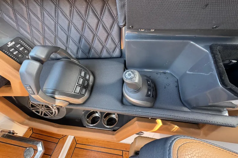 Slide: The Image of 2024 Cobalt R33 boat control panel with joystick and throttle levers. - 29