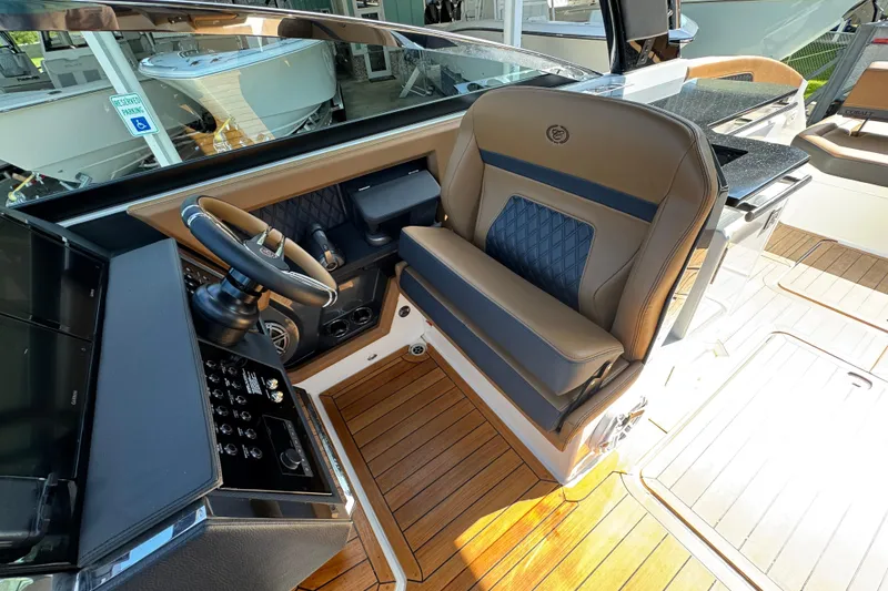 Slide: The Image of 2024 Cobalt R33 boat interior with luxurious seating and modern steering console. - 30