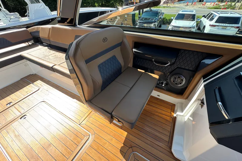 Slide: The Image of 2024 Cobalt R33 boat interior with luxurious seating and wood flooring. - 31