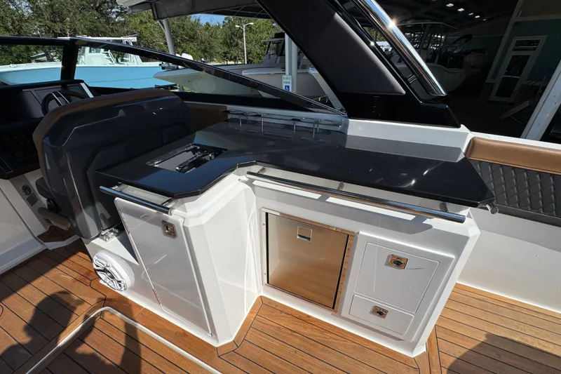 Slide: The Image of 2024 Cobalt R33 boat interior with sleek kitchen area and modern design. - 34