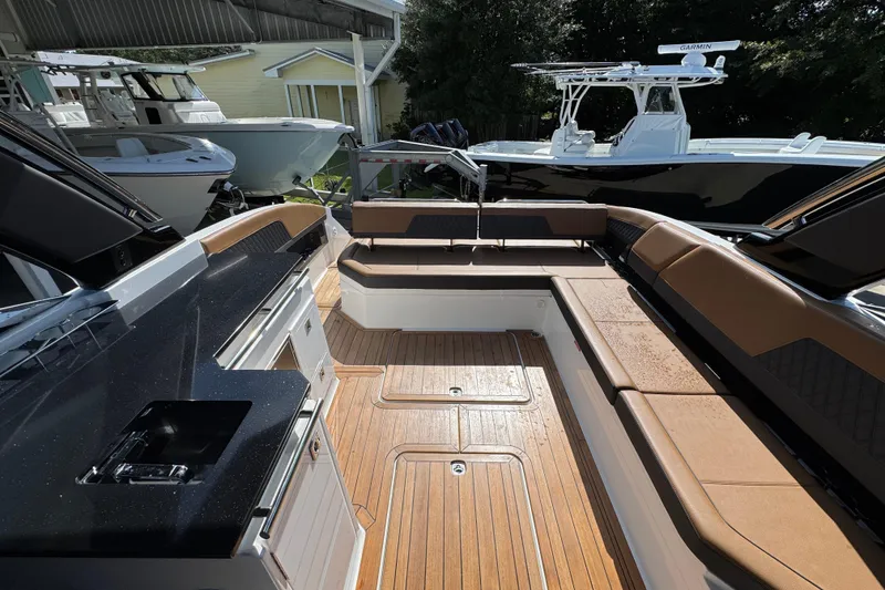 Slide: The Image of 2024 Cobalt R33 boat interior with luxurious seating and sleek design. - 36