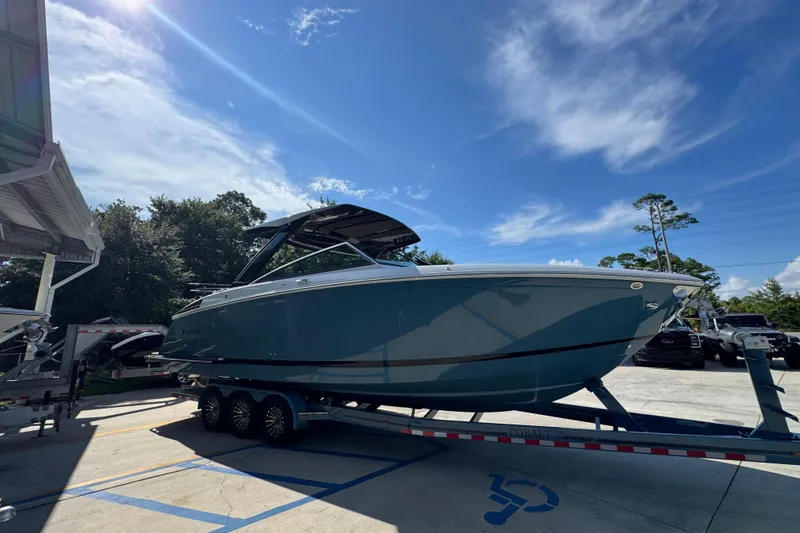 Slide: The Image of 2024 Cobalt R33 boat on trailer under clear blue sky. - 9